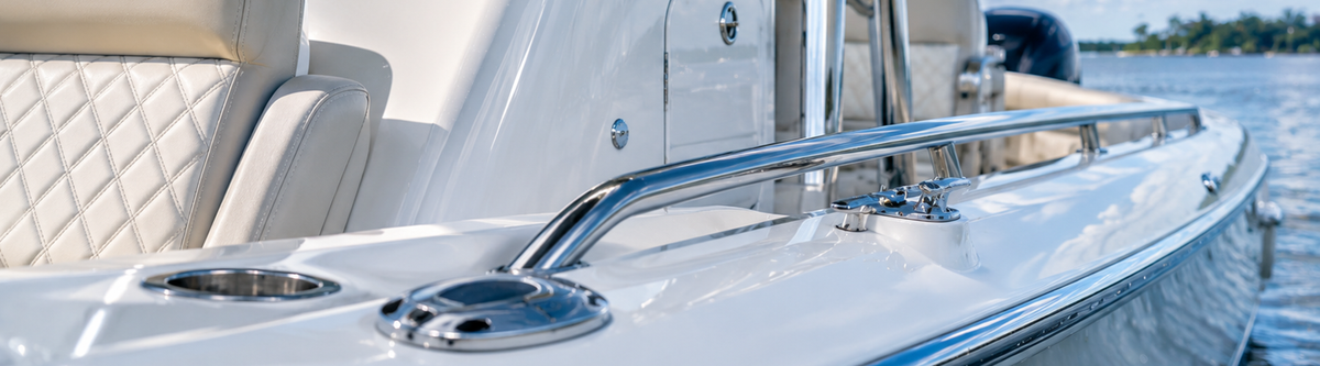 Boat's polished chrome rail, cleat, and cup holder.