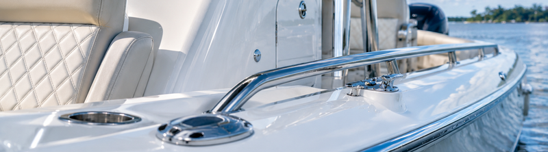 Boat's polished chrome rail, cleat, and cup holder.